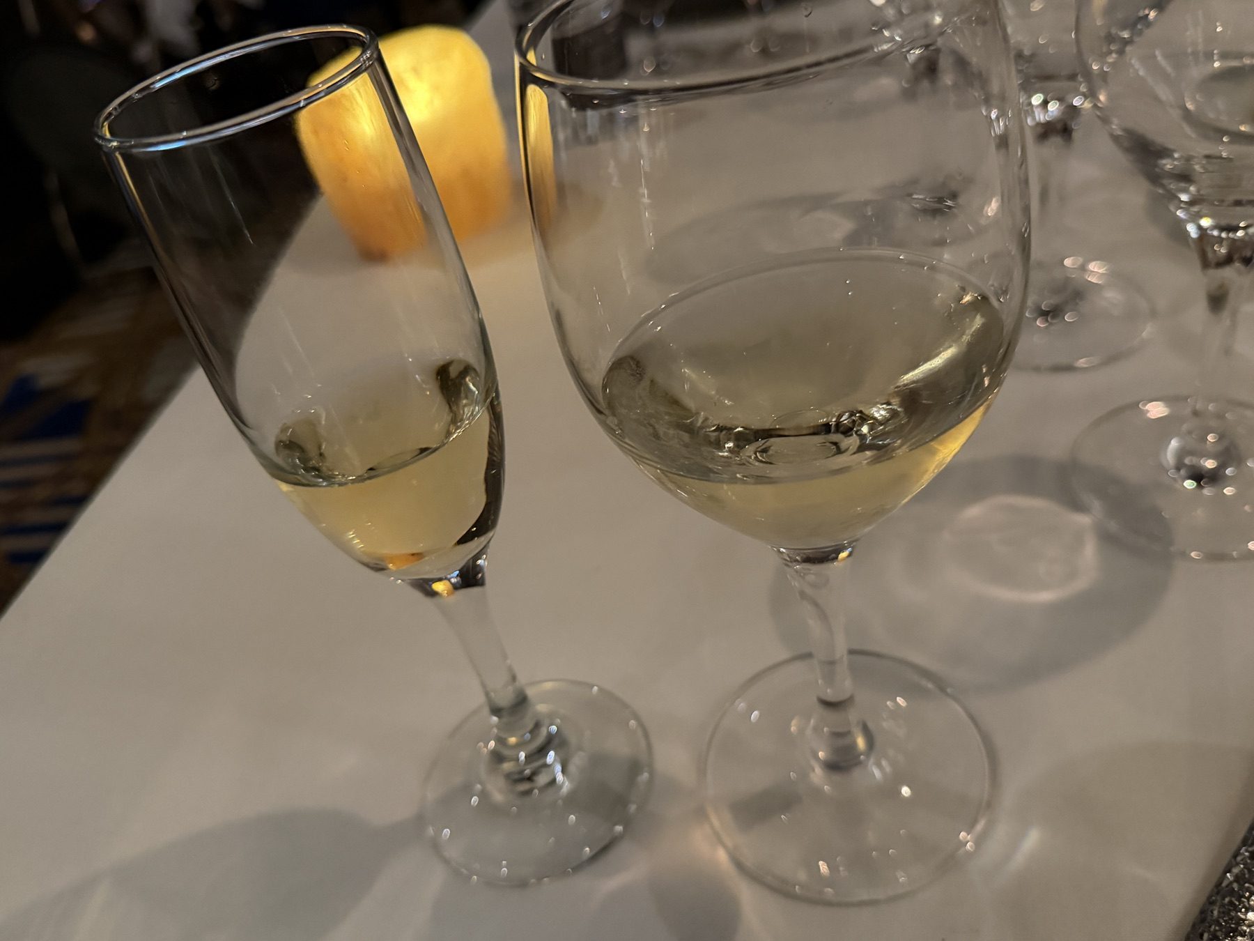 Brut in a flute beside a glass of Chardonnay