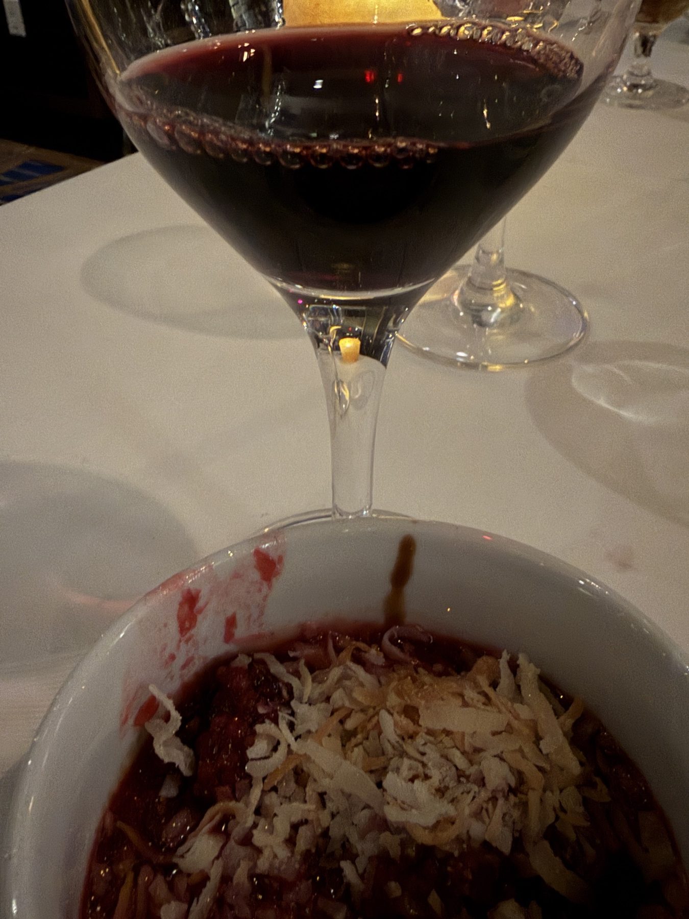Dark chocolate pot de crème beside a glass of Grand Cheval