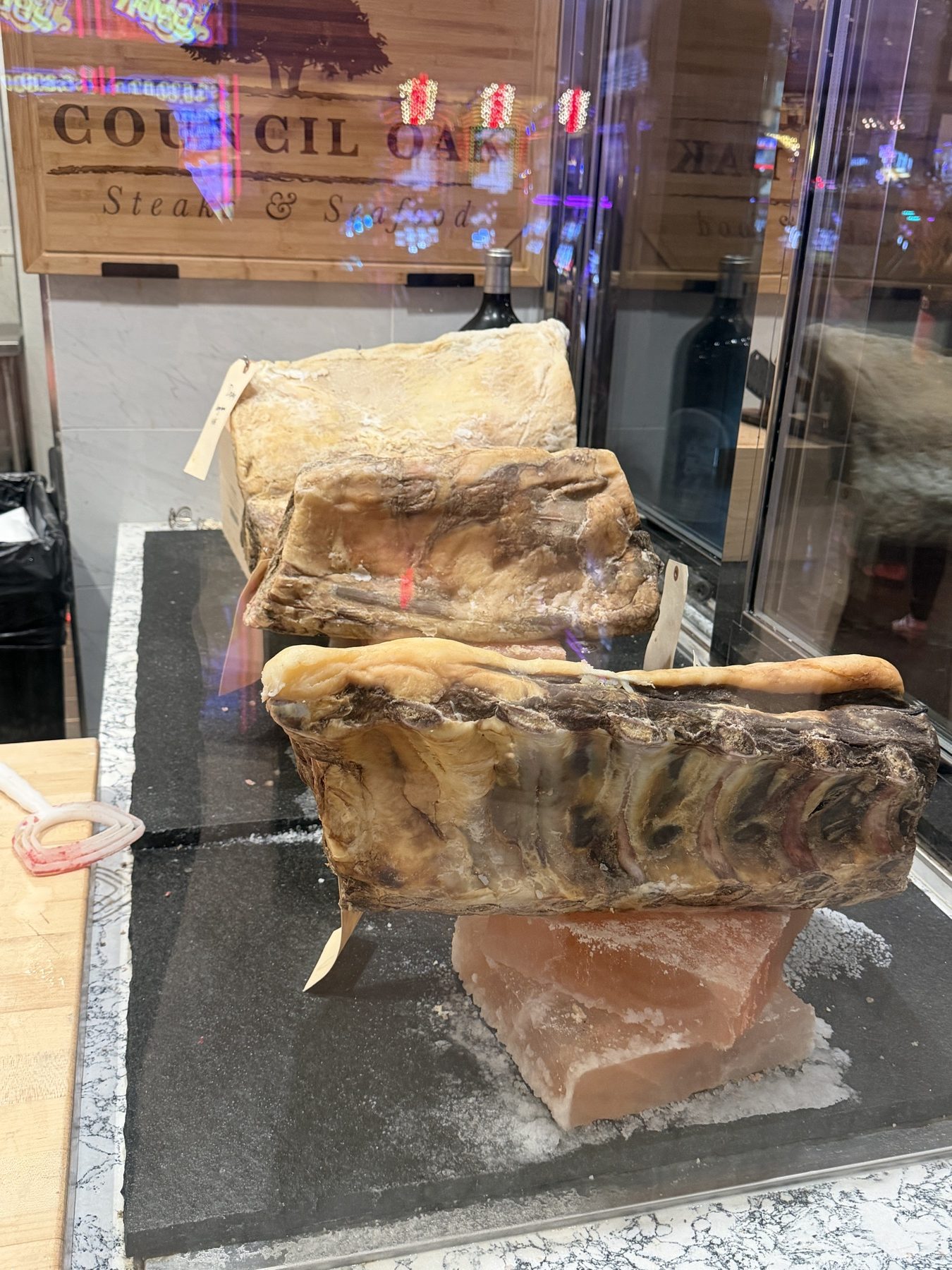 Dry-aged beef on Himalayan salt beside the Council Oak sign