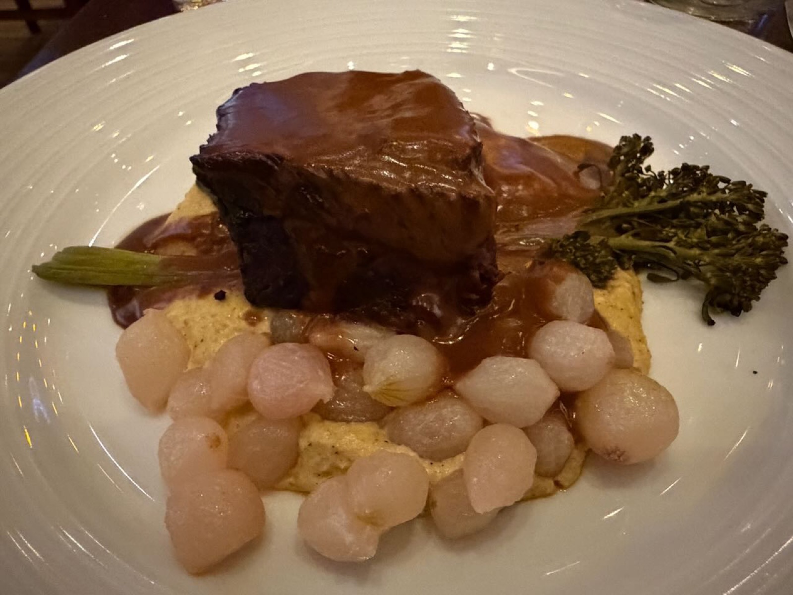Braised short rib with corn puree and pearl onions