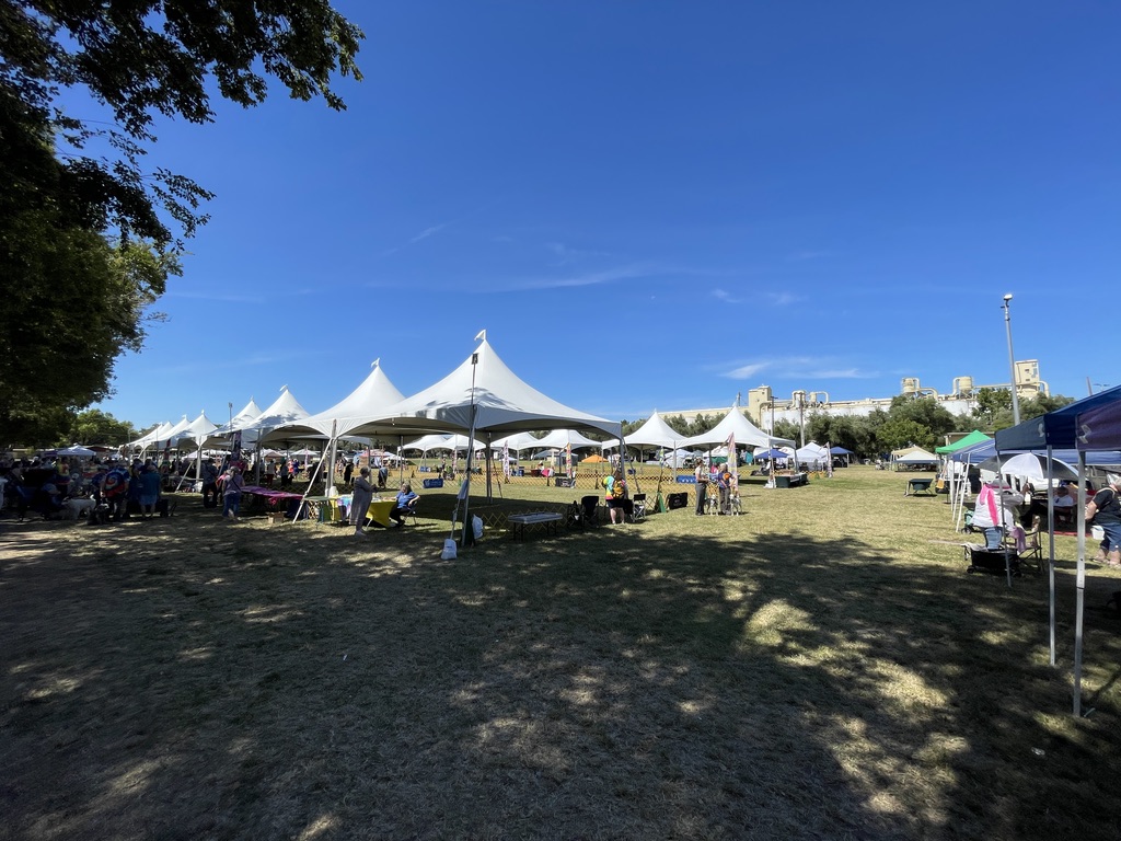 Rows of white event tents across the outdoor show field